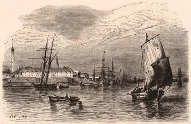 View of the Port of Lorient, Morbihan, Brittany, France: sailboats and boat in the foreground, harbor buildings and lighthouse in the background
