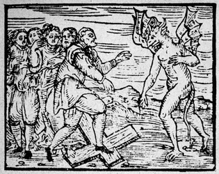 Witchcraft: the devil and the men walking on the Catholic cross - engraving