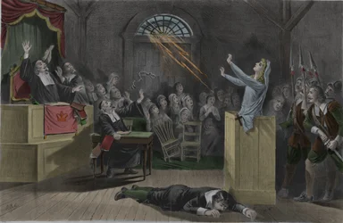 A lightning burns the chains of a witch during her trials in Salem