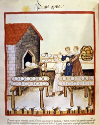 Black bread: a baker at work in front of an oven. Illumination from the milking of medicine and dietetics Tacuinum sanitatis
