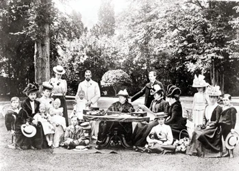 Members of the British Royal Family including King George V, King Edward VIII around Queen Victoria at a garden party