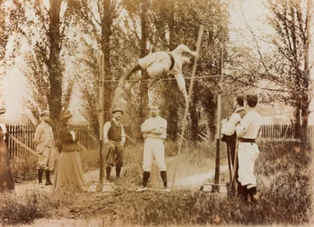 Portrait of a man who trains in the pole vaulting in front of some spectators