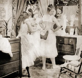 Reducing the Surplus, stereoscopic card depicting a young woman being laced into a corset, c.1900