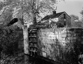 Antique lock on or near the Potomac River is viewed by boys