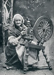 An Old Irish Woman at Her Spinning-Wheel