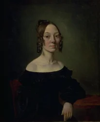 Portrait of a Girl in a Black Dress Sitting at a Table