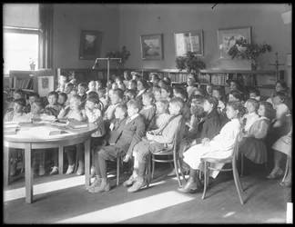Children Seated, Listening in the Reading Room of an Unidentified Branch of the Queens Borough Public Library, c.1910