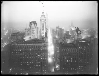 High-angle Misty Night View of Lower Manhattan Looking North, with the Singer Building, Woolworth Building, and Municipal Building Visible, c.1913