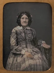 Seated Elderly Woman Wearing Plaid Dress and Bonnet