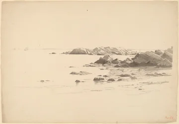 Rocklined Beach with Distant Boats