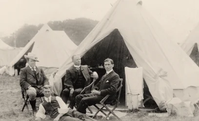 Men relaxing outside their tent
