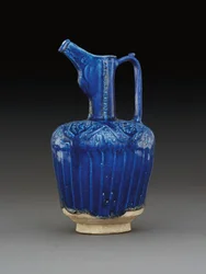 Nishapur moulded monochrome cobalt-blue glazed pottery ewer, Eastern Iran